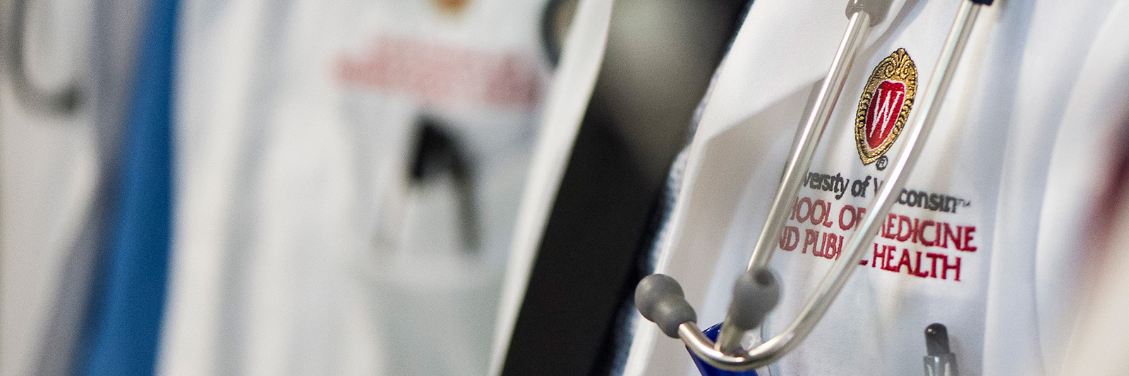 Close-up of a white laboratory coat with a stethoscope draped over the shoulder.