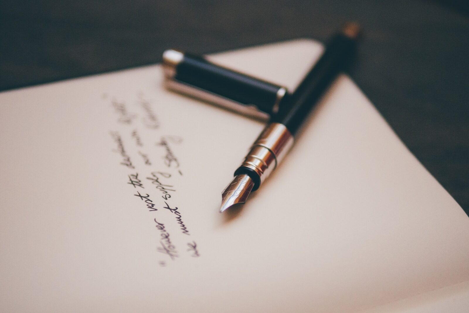 Image of a fountain pen on a piece of white paper