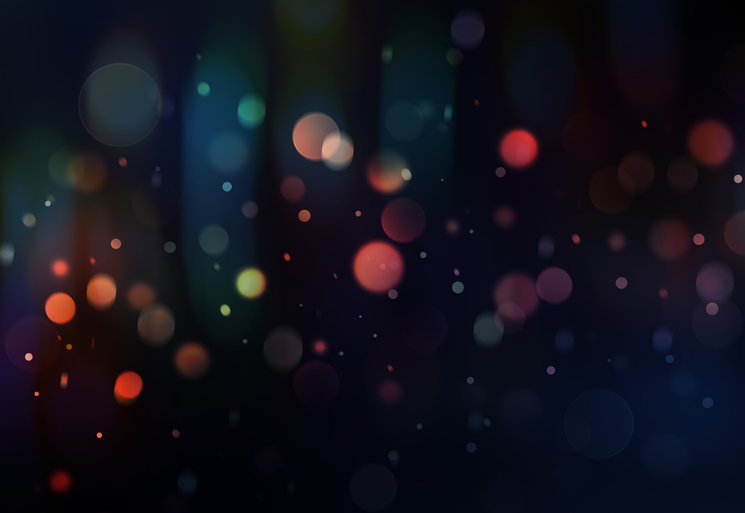 image of blurry colored glitter on dark background 